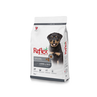 A bag of Reflex Puppy Food with Lamb & Rice. The packaging is predominantly white with a picture of a black puppy on the front and product details.