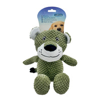 Green plush dog toy with a packaging label on a white background