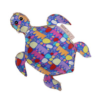 A multicolored plush turtle toy made from jute fabric with a visible squeaker and decorated with a pattern of colorful circles.